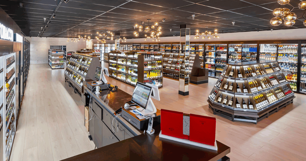 Modern liquor store interior with premium wines, spirits, and vodkas on display in sleek, well-lit shelving.