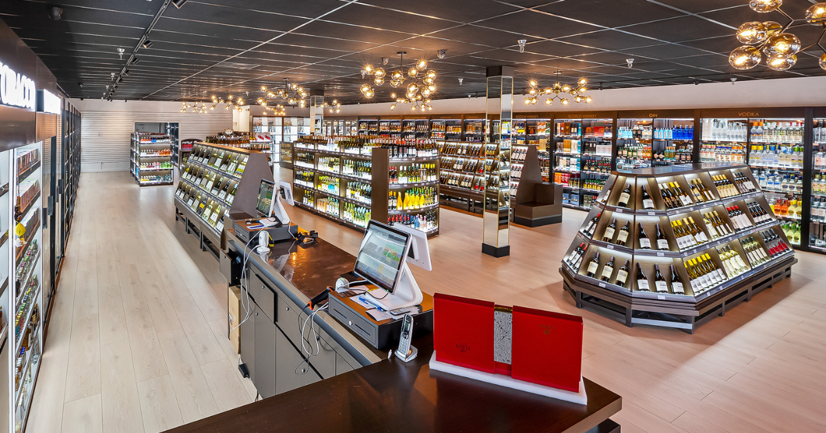 Modern liquor store interior with premium wines, spirits, and vodkas on display in sleek, well-lit shelving.
